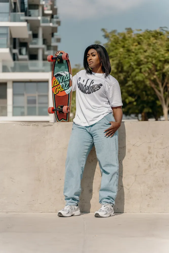 Skater in streetwear holding a cruiser board