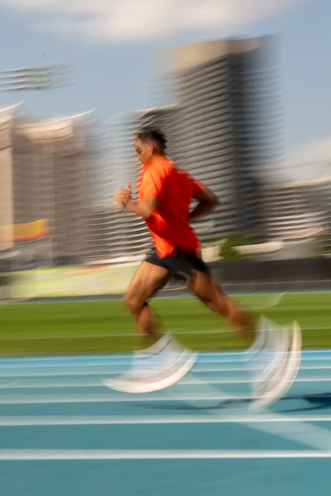 Motion-blurred sprinter on an athletics track